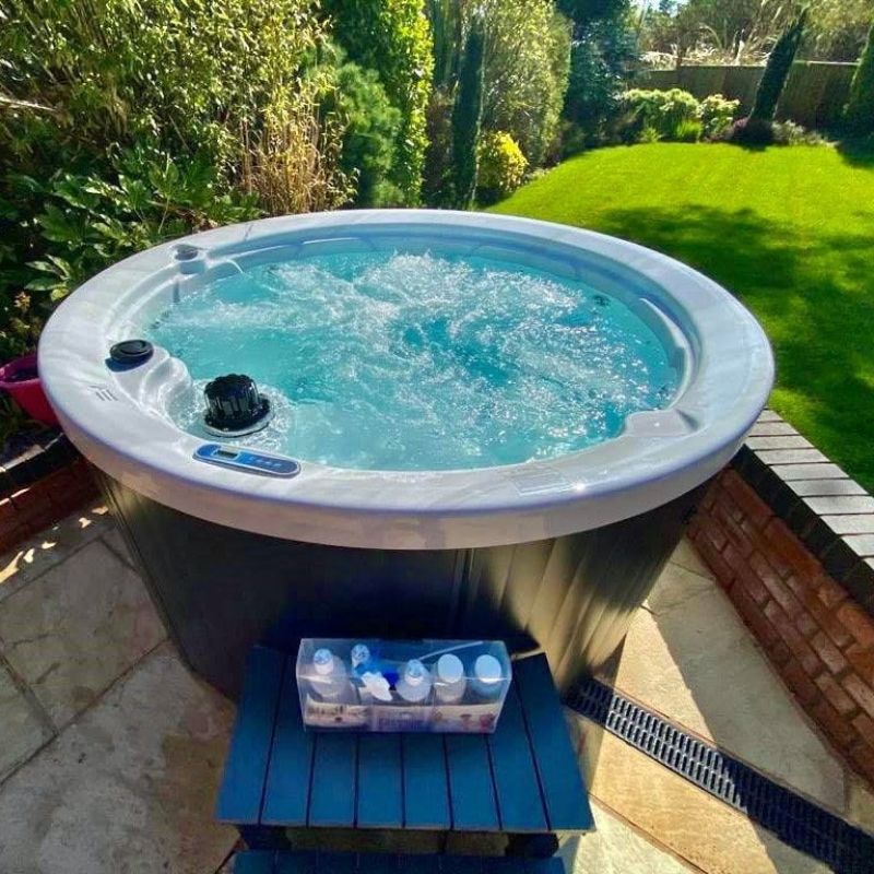 outdoor hot tub spa with bubbling water in garden patio setting