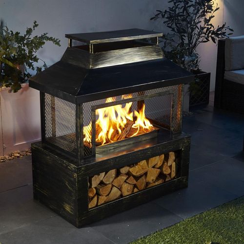 modern outdoor fire pit with burning flames and log storage on patio